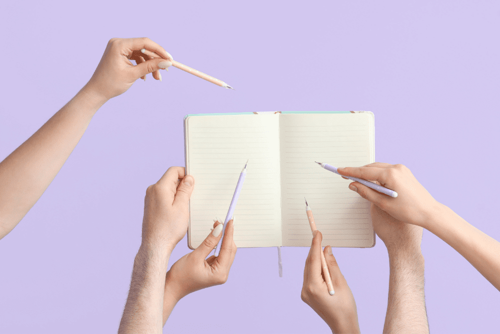 Notebook with hands representing people critiquing case studies
